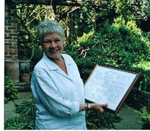 Our President Dame Judi Dench holding her family tree presented by the Society